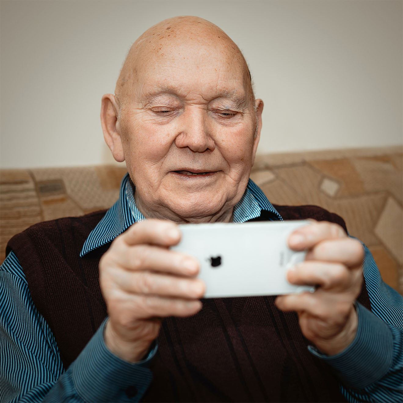 Resident using his phone whilst staying at Silverleigh Care Home for Respite Care.