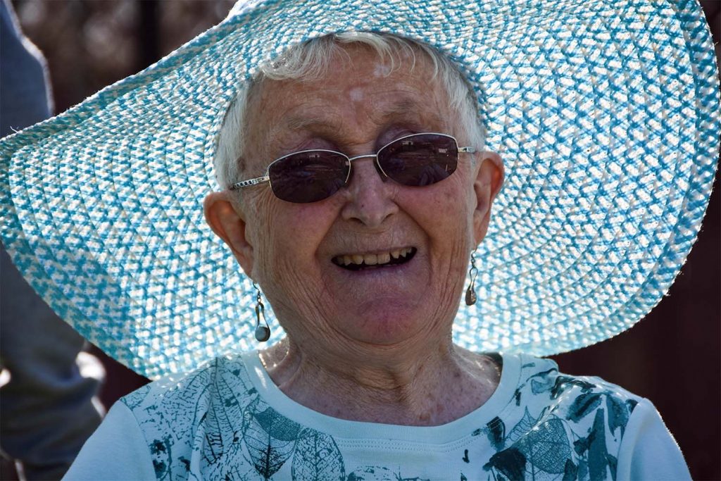 resident smiling with hat on