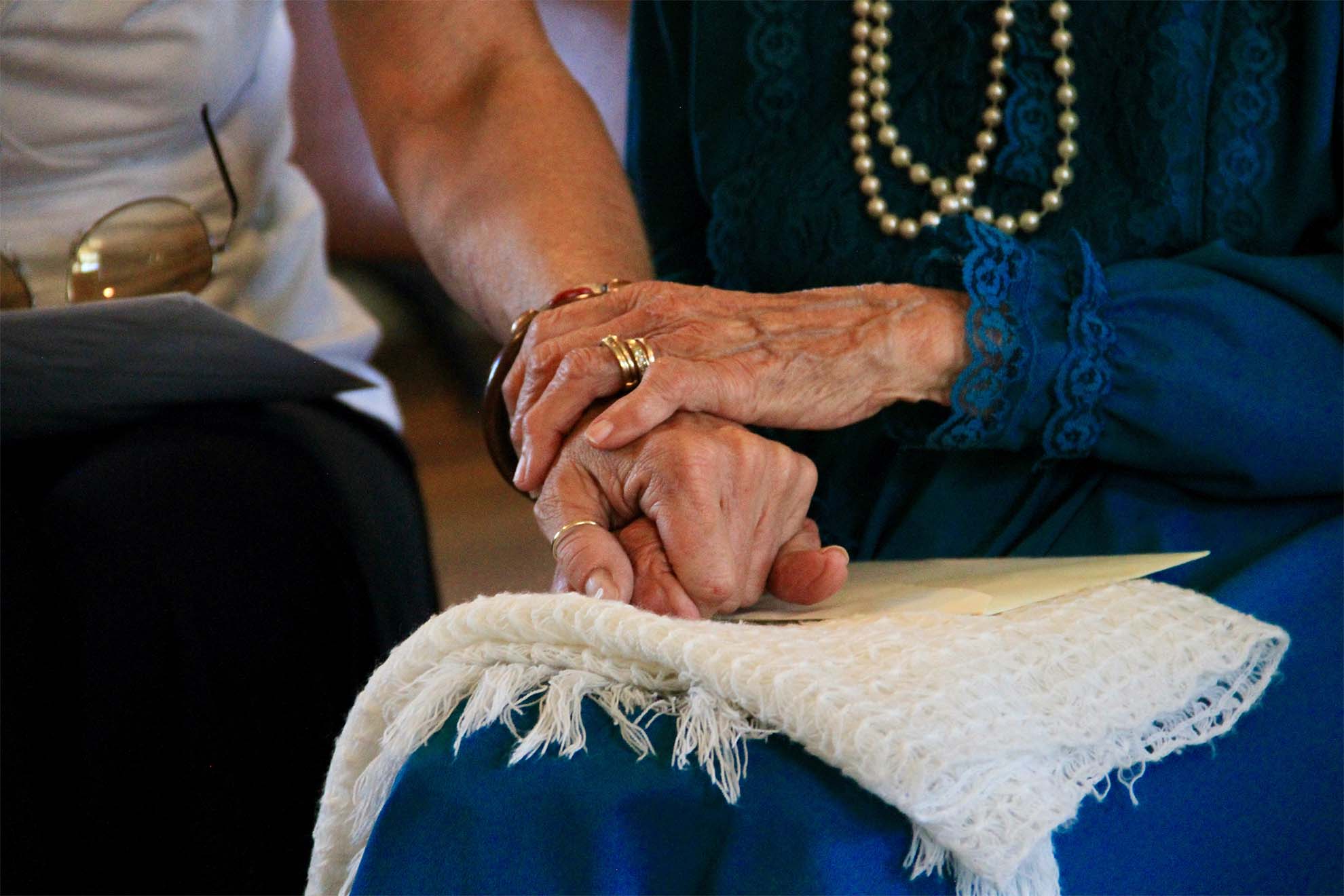 resident holding hands with carer