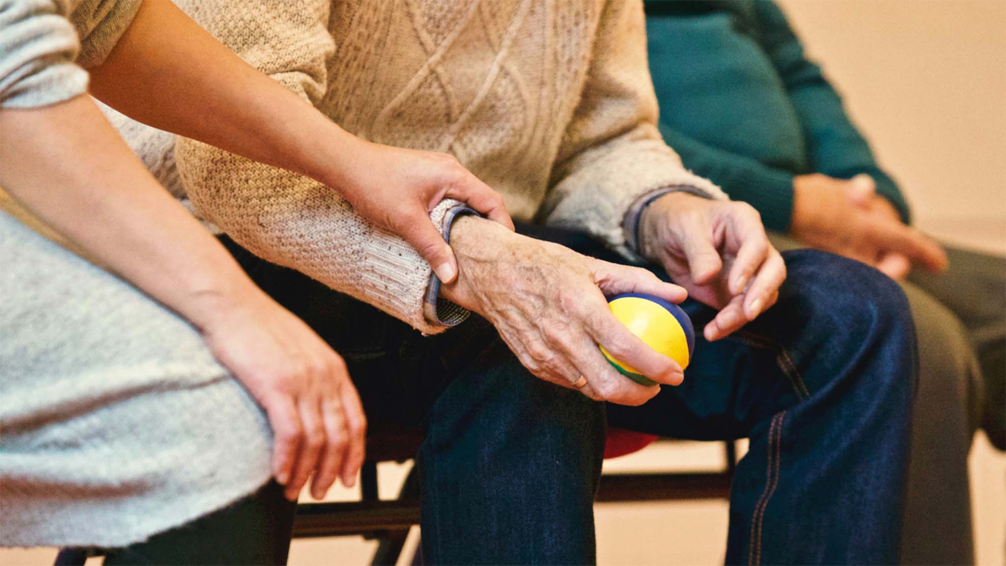 resident holding hands with carer