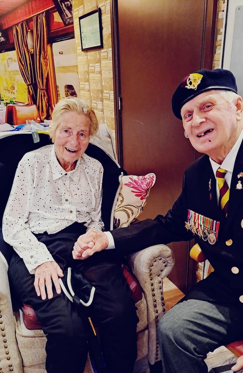 man sat with his wife in his uniform on VE day