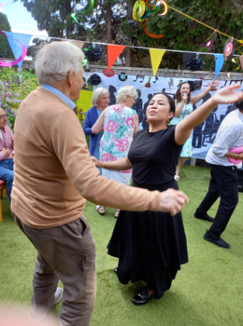Staff and resident dancing at summer party