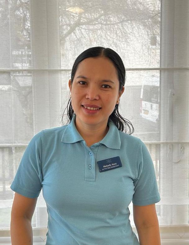 Woman smiling in care home uniform