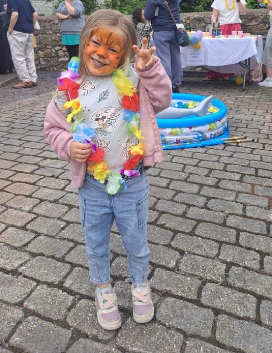 a girl with her face painted like a tiger