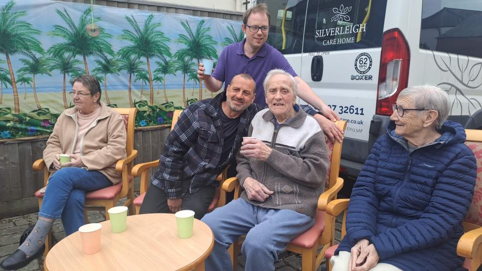 older adults sat down outside
