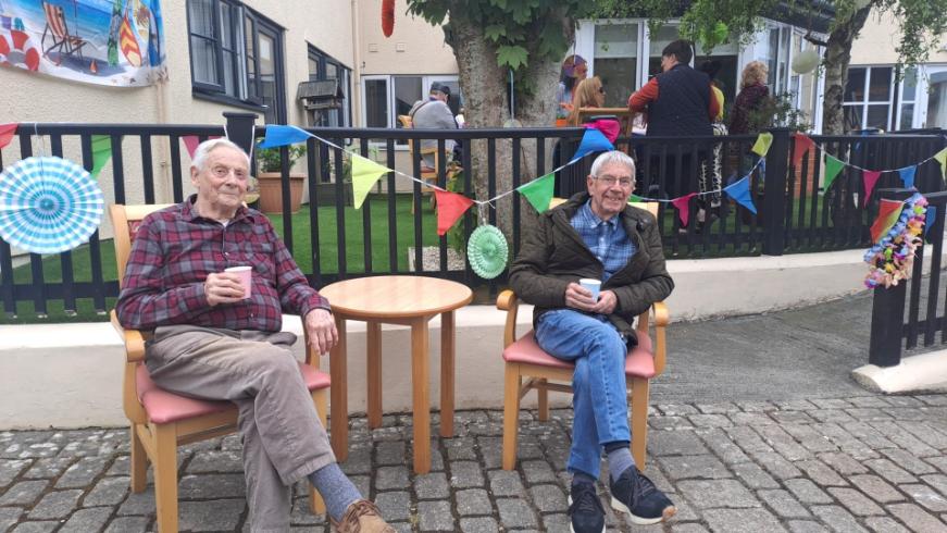 older adults sat down outside