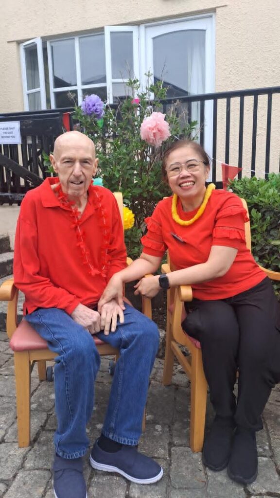 two people in red shirts sat down together